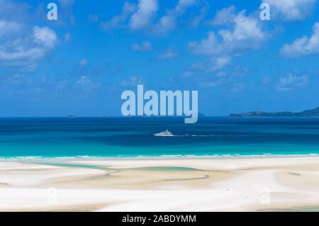 Weiße Schiff, Boot am türkisblauen Wasser der Coral Sea an einem sonnigen Tag. Sommer Urlaub Hintergrund. Whitsundays Whitehaven Beach. Queens Stockfoto