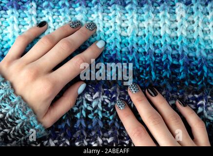 Womans Hände mit Maniküre in gestrickte Wolle Pullover Stockfoto
