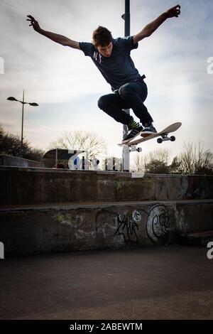 Skateboarder Ollie aus hohen Schritte auf das Konkrete unten, gefährliches Abenteuer, Extremsport, professionelle Skater, Skateboard Stockfoto