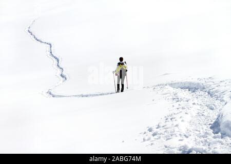 Einsam mit Schneeschuhen in den frischen Schnee Stockfoto