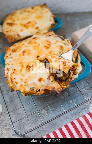 Leckere heiße Lasagne in kleinen blauen backen Topf Stockfoto