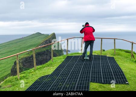 Nebel Blick auf den alten Leuchtturm aus Sicht mit touristischen Fernglas auf der Insel Mykines, Färöer, Dänemark. Landschaftsfotografie Stockfoto