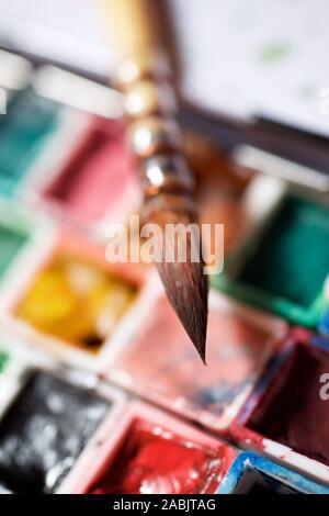 Box mit Wasserfarben und Pinsel. Stockfoto