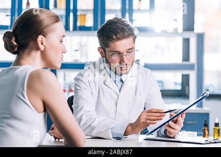 Selektiver Fokus der Allergologe holding Zwischenablage in der Nähe von Patienten in der Klinik Stockfoto