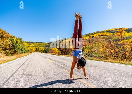 Schöne Frau macht Handstand an der schwarzen Schlucht des Gunnison Stockfoto