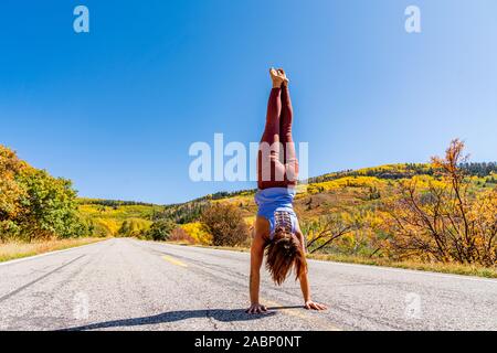 Schöne Frau macht Handstand an der schwarzen Schlucht des Gunnison Stockfoto