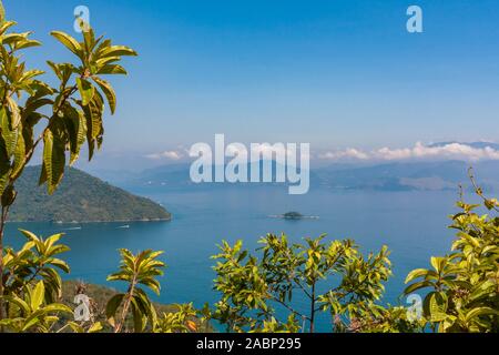 Ilha Grande, Brasilien. 24. Dezember, 2012. Atemberaubende Aussicht auf die Bucht Enseada Santorini (Santorini), off (aus) (Vila do Santorini Santorini Dorf), von der Spur Suche während der wunderschönen sonnigen Tag, Sicht auf dem Weg in Palmas, die Ilha Grande (Grosse Insel), die Gemeinde von Angra dos Reis, Bundesstaat Rio de Janeiro, Brasilien. Am 5. Juli 2019, Ilha Grande wurde von der UNESCO als Weltkulturerbe eingetragen. Stockfoto