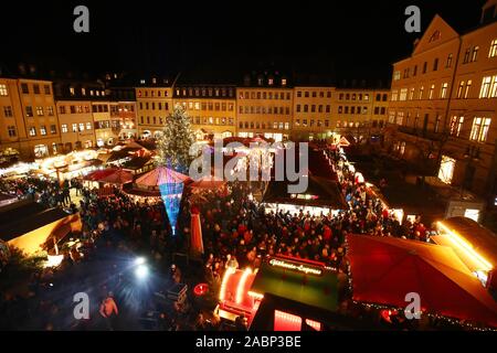 Gera, Deutschland. 28 Nov, 2019. Besucher stehen auf dem Marktplatz bei der Eröffnung des Weihnachtsmarktes. In der Mitte ist ein festlich beleuchtet 18 Meter High Colorado Tannen aus Weimar. Credit: Bodo Schackow/dpa-Zentralbild/dpa/Alamy leben Nachrichten Stockfoto