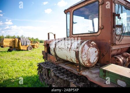 Landwirtschaftliche Geräte. Alten verrosteten Traktor. Vorbereitung für die Verwendung auf dem Feld. Der gastank auf dem Traktor. Stockfoto