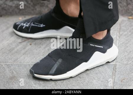 Mailand, Italien - 19 SEPTEMBER 2019: Mann mit Yohji Yamamoto schwarzen und weißen Turnschuhen vor Emporio Armani Fashion Show, Mailand Fashion Week street Styl Stockfoto