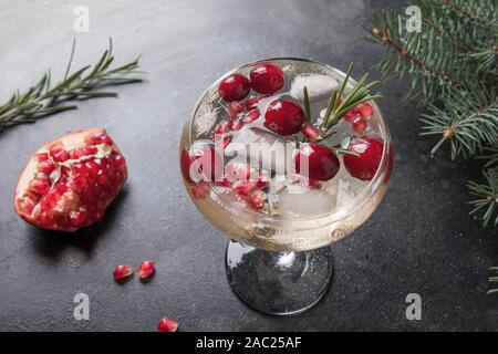 Granatapfel Weihnachten Cocktail mit Rosmarin, Champagner, club Soda auf Schwarz. Close Up. Stockfoto