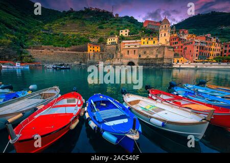 Wunderschönes Resort bei Sonnenuntergang mit bunten mediterranen Gebäude und hölzerne Fischerboote im Hafen. Vernazza, Cinque Terre, Italien, Europa Stockfoto