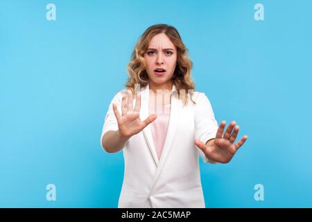 Nein, ich habe Angst! Portrait von verängstigte Frau mit gewelltes Haar in weisse Jacke heben die Hände im Stop Geste, mit Angst in den Augen, Stress überrascht Stockfoto