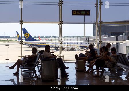 Barcelona, Spanien - 11. August 2019: die Passagiere der Boarding Gate am Flughafen warten, mit Ryanair Flugzeug im Hintergrund Stockfoto