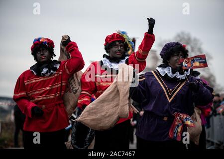 Krefeld, Deutschland. 01 Dez, 2019. Mehrere "Zwarten Piets" (Schwarzer Peter) kommen mit der Sinterklaas (Nicholas) von Venlo am Steiger in Krefeld mit dem Boot. Traditionell wird der "Zwarten Piets" Süßigkeiten an die Kinder verteilen. In den Niederlanden, der schwarz lackierte Helfer des Sinterklaas sind heute umstritten. Vor ein paar Tagen gab es Proteste mit mehreren Verhaftungen in Apeldoorn. Credit: Fabian Strauch/dpa/Alamy leben Nachrichten Stockfoto