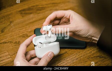 Paris, Frankreich, 30. Oktober 2019: Ansicht von Frau Hände unboxing neue Apple Computer AirPods pro Kopfhörer mit aktiver Geräuschunterdrückung für Immersive Sound - Rückansicht des Pakets Stockfoto