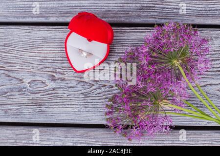 Lila Blumen und Samt-Box mit Ring. Stockfoto