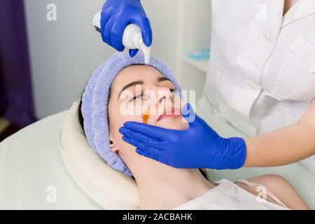 Junge schöne Mädchen in Gesichtsmassage Entspannen im Spa Salon. Bild der Frau in der Spa Salon liegen auf dem massage Schreibtisch Stockfoto