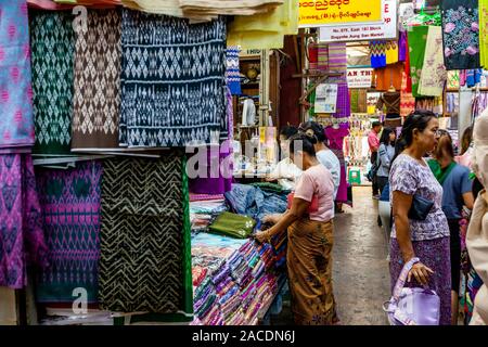 Frauen Shopping für Textilien/Kleidung bei der Bogyoke Aung San Markt, Yangon, Myanmar. Stockfoto