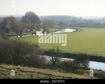 Blick vom Damm das war Fotheringhay Castle, mit Blick auf Biegungen in den Fluss Nene mit der umliegenden Landschaft im Winter die Sonne. Stockfoto