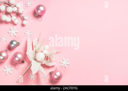 Weihnachten flach Hintergrund mit rosa und weißen Dekorationen auf Rosa. Stockfoto