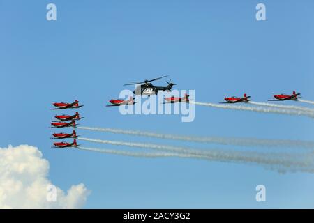 Payerne Flugshow, Schweizer PC-7 Team und Hubschrauber im Formationsflug Stockfoto