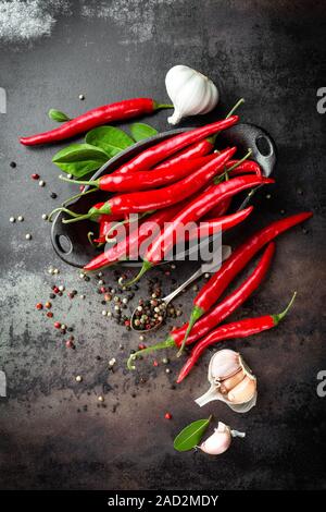 Red hot Chili peppers Hühneraugen und Hülsen auf dunklen alten Metall kulinarischen Hintergrund Stockfoto