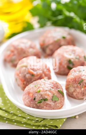 Rohe Frikadellen auf weißen Teller, Kochen in der Küche Stockfoto
