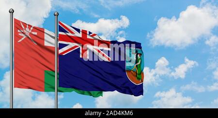 Oman und Montserrat Flagge im Wind gegen Weiße bewölkt blauer Himmel zusammen. Diplomatie Konzept, internationale Beziehungen. Stockfoto