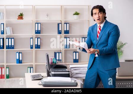 Junge Mitarbeiter von Kopien beim Kopieren von Maschine Stockfoto