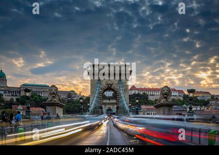 Budapest, Ungarn - Schwere Nachmittag der Verkehr auf der ikonischen Széchenyi Kettenbrücke bei Sonnenuntergang mit schönen Himmel und Wolken Stockfoto