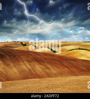 Blitz über dem Feld. malerische hügelige Feld Stockfoto