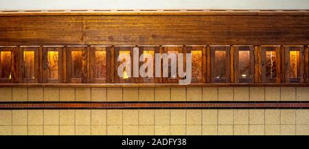 Holz und Glas Reihe von Postfächern in der Eingangshalle von einem Art déco-Gebäude. Stockfoto