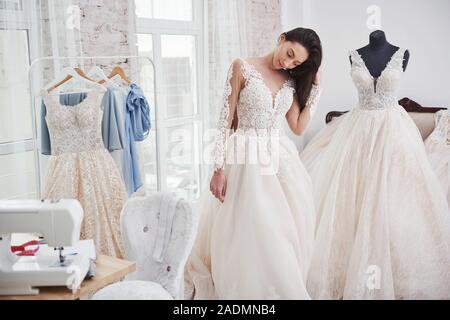 Posieren für Fotos schauen Sie später zu nehmen. Der Prozess der Montage das Kleid im Studio von Hand gestaltete Kleidung Stockfoto