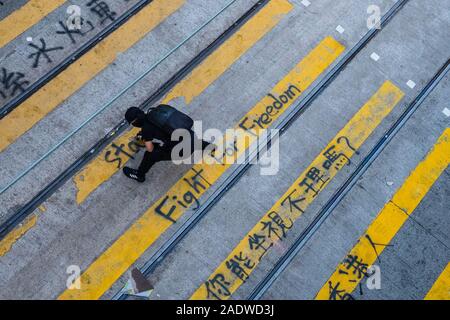 HongKong - November, 2019: Demonstrant schreibt Graffiti auf fußgängerüberweg während der 2019 HongKong Proteste, Demonstrationen in Hongkong gestartet als Anti-Extradition Gesetz änderung Rechnung (Anti-Elab) Bewegung. Stockfoto