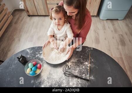 Sie suchen. Mutter lehrt Tochter die Eier für das Osterfest zu malen Stockfoto