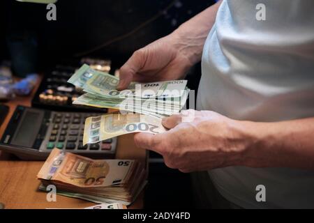 Euro-banknoten Mann zählen Bargeld auf Zähler Stockfoto
