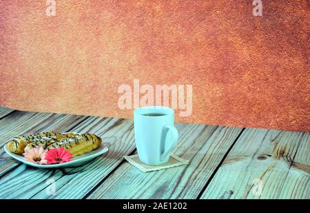 Drei frische eclairs liegen auf einem weißen Keramik Platte mit blütenknospen eingerichtet, neben einer Tasse schwarzen Tee auf einen textilen Serviette. Close-up. Stockfoto