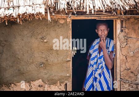 Gleichen, Tansania, 6. Juni, 2019: Massai-frau mit Blick auf ihre Tür Stockfoto