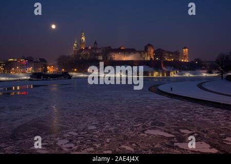 Nacht Blick auf historischen königlichen Schloss Wawel in Krakau, Polen, und gefrorene Weichsel im Winter Stockfoto