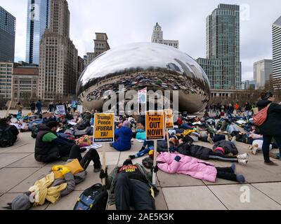 Chicago, Illinois, USA. 6. Dezember 2019. Klimawandel Demonstranten halten ein 'die in "Cloud Gate in Millennium Park während der heutigen Rallye und März. Stockfoto