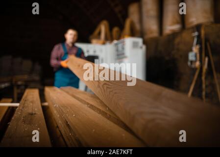 Zimmermann arbeitet auf holzbearbeitungsmaschine, Bauholz Stockfoto