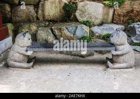 Steinbank nahe dem Eingang zum haedong Yonggungsa Tempel in Busan, Südkorea. Stockfoto