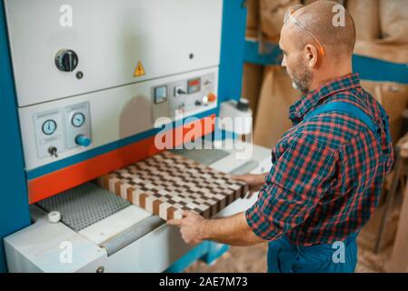Zimmermann arbeitet auf holzbearbeitungsmaschine, Fabrik Stockfoto