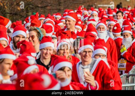 London, Großbritannien. 08 Dez, 2019. London Santa Dash 2019 - Tausende von verkleidet als Weihnachtsmann auf eine optionale 5k- oder 10k London Santa Dash Kurs in Brockwell Park zu helfen, Kapital für schwer kranke Kinder aus ganz Großbritannien heben, die betreut werden, für die in der Great Ormond Street Hospital (GOSH). Credit: Guy Bell/Alamy leben Nachrichten Stockfoto