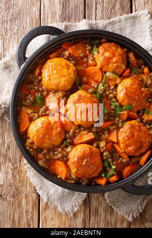 Leckere Hackfleischbällchen gedünstet mit Linsen und Gemüse close-up in einer Pfanne auf dem Tisch. Vertikal oben Ansicht von oben Stockfoto