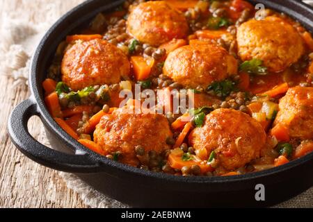 Hackfleischbällchen mit Linsen und Gemüse in Tomatensauce close-up in einer Pfanne auf dem Tisch. Horizontale Stockfoto