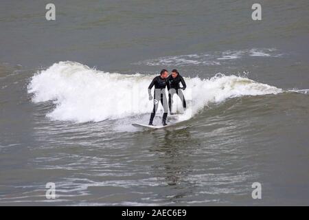 Bournemouth, Dorset UK. 8. Dezember 2019. UK Wetter: Wind und Wellen Zunahme der Größe als Sturm Atiyah Ansätze in Bournemouth Strand als Surfer das Beste aus den Bedingungen zu machen. Credit: Carolyn Jenkins/Alamy leben Nachrichten Stockfoto