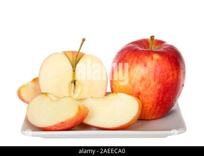 Eine ganze Gala Apfel mit einem auf einem kleinen rechteckigen Platte isoliert auf weißem geschnitten. Gala ist eine Klonal vermehrten Apple cultivar mit einer milden und Swee Stockfoto