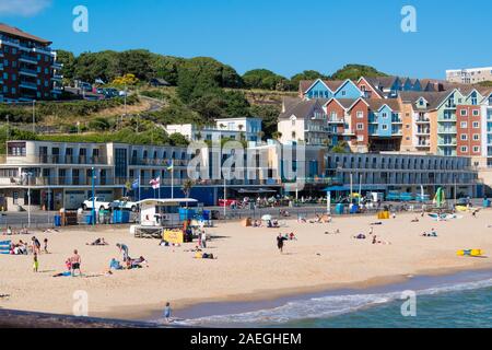 Urlauber auf der RNLI bewachten Strand bei Durley Chine, West Cliff Bournemouth, Dorset England UK Stockfoto